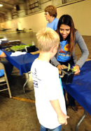 Image of Team Vidak’s Daniel Medina and Francesca Dove volunteering at Kings County Farm Day.