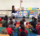 Image of Team Vidak’s Ana Orozco reading to kindergarten class at Pioneer Union Elementary School in Hanford.